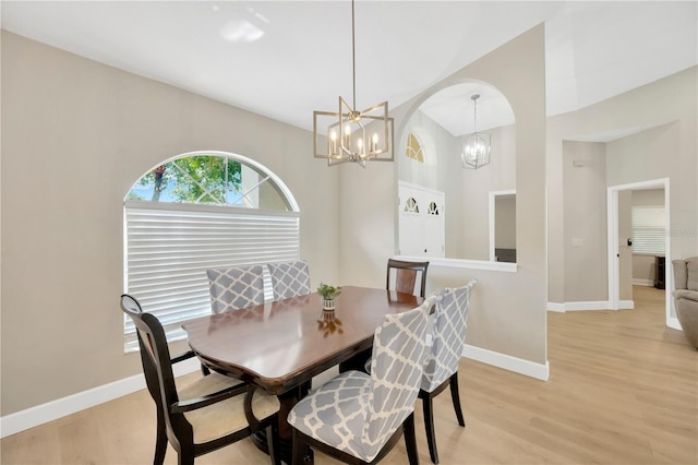 4617 Basswood St, Land O Lakes, FL 34639 - dining space with a chandelier, light wood-type flooring, and arched walkways