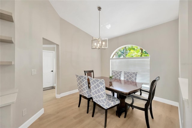 4617 Basswood St, Land O Lakes, FL 34639 - dining area with a chandelier, light wood-style floors, and high vaulted ceiling