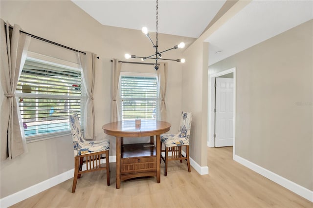 4617 Basswood St, Land O Lakes, FL 34639 - dining space with a chandelier, light wood finished floors, and lofted ceiling