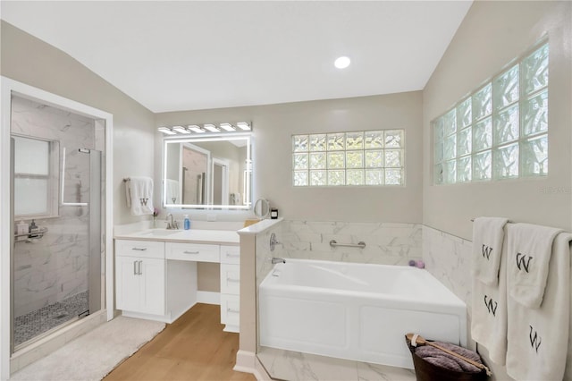 4617 Basswood St, Land O Lakes, FL 34639 - bathroom with a bath, a shower stall, vanity, and wood finished floors