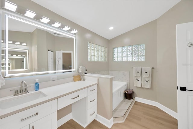 4617 Basswood St, Land O Lakes, FL 34639 - full bath with vanity, a garden tub, wood finished floors, and lofted ceiling