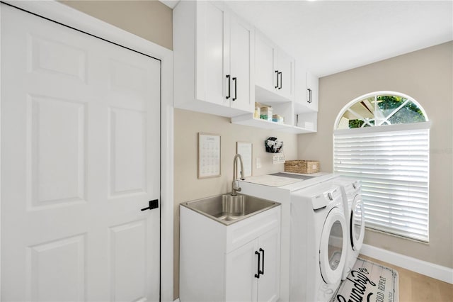 4617 Basswood St, Land O Lakes, FL 34639 - washroom featuring independent washer and dryer, cabinet space, and light wood finished floors