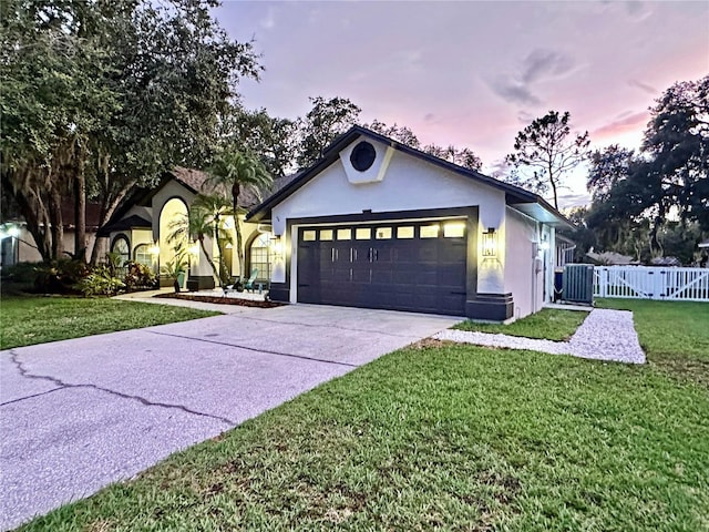 4617 Basswood St, Land O Lakes, FL 34639 - ranch-style house featuring stucco siding, driveway, a gate, and a garage