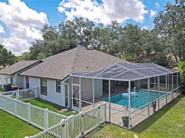 4617 Basswood St, Land O Lakes, FL 34639 - back of property featuring a shingled roof, an outdoor pool, a fenced backyard, a patio, and stucco siding