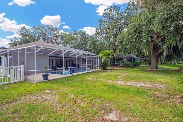 4617 Basswood St, Land O Lakes, FL 34639 - view of grassy yard with an outdoor pool, a patio, and a lanai