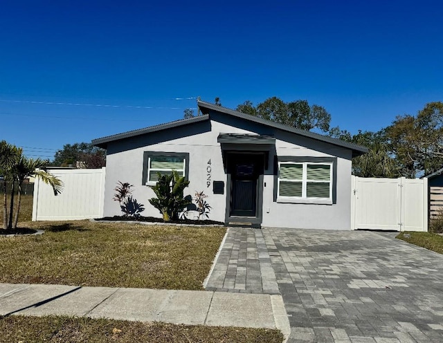 4029 9th Ave S, Saint Petersburg, FL 33711 - view of front of home with stucco siding and a gate