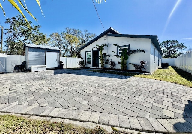 4029 9th Ave S, Saint Petersburg, FL 33711 - rear view of house featuring a patio area, a fenced backyard, and a storage shed