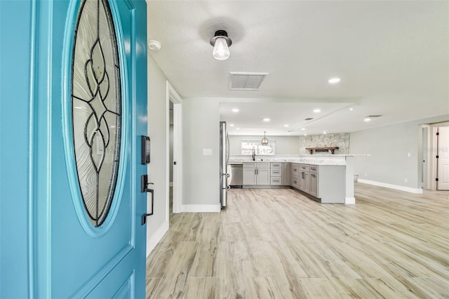13909 Berkowitz Ave, Hudson, FL 34667 - entryway with light wood finished floors and recessed lighting