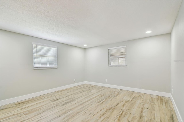 13909 Berkowitz Ave, Hudson, FL 34667 - spare room featuring wood finished floors and recessed lighting