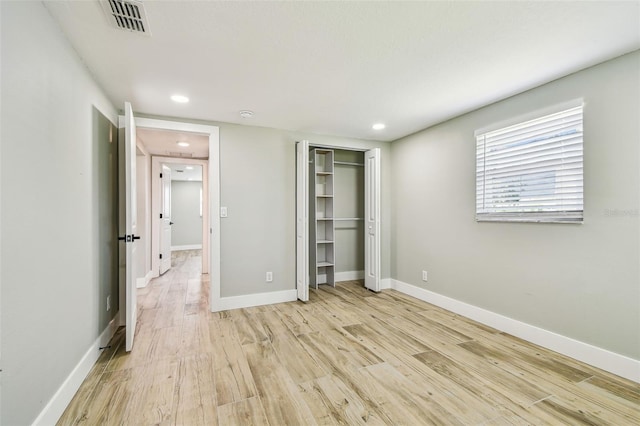 13909 Berkowitz Ave, Hudson, FL 34667 - unfurnished bedroom with light wood finished floors, recessed lighting, and a closet