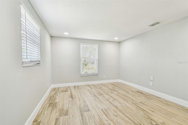 13909 Berkowitz Ave, Hudson, FL 34667 - empty room featuring wood finished floors and recessed lighting