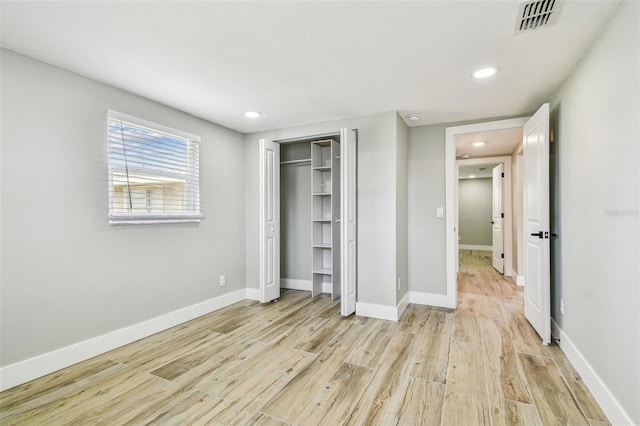 13909 Berkowitz Ave, Hudson, FL 34667 - unfurnished bedroom featuring light wood-style flooring, recessed lighting, and a closet