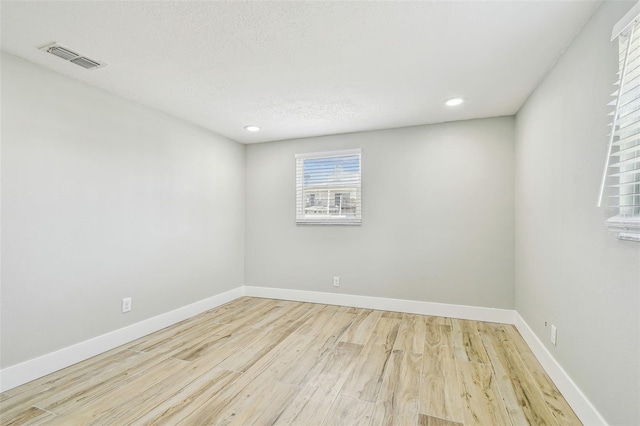 13909 Berkowitz Ave, Hudson, FL 34667 - empty room with wood finished floors and recessed lighting
