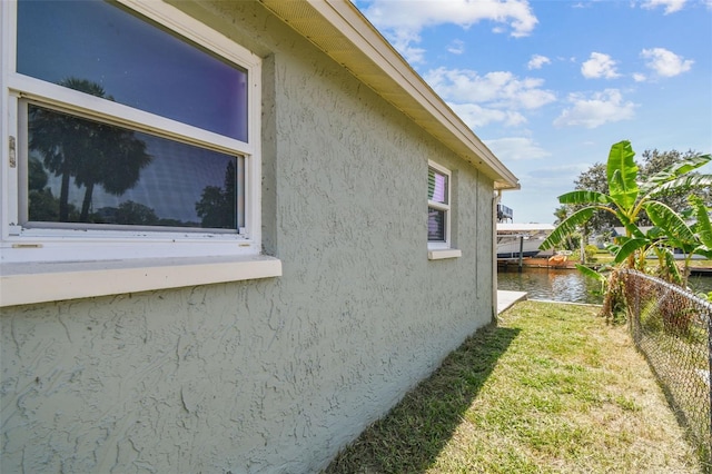 13909 Berkowitz Ave, Hudson, FL 34667 - view of property exterior featuring stucco siding and a water view