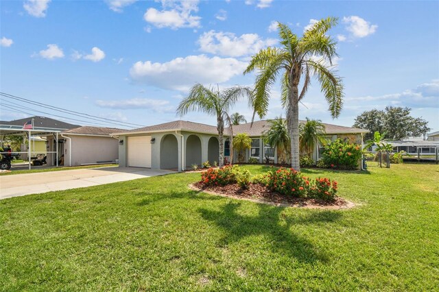 13909 Berkowitz Ave, Hudson, FL 34667 - ranch-style home with driveway, an attached garage, a front lawn, and stucco siding