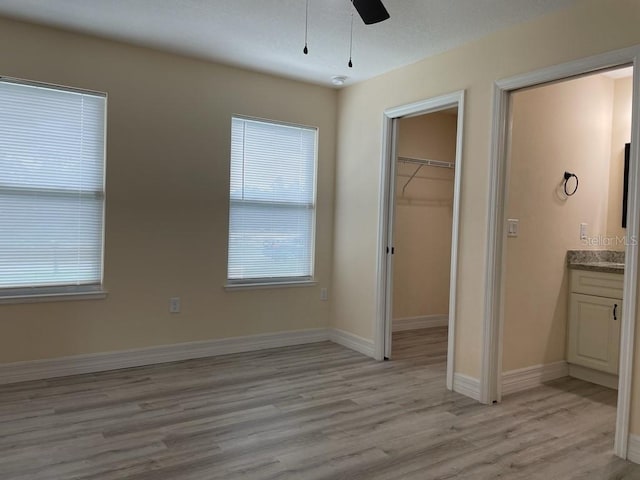 16910 SW 27th Ave, Ocala, FL 34473 - unfurnished bedroom featuring light wood-style flooring, a spacious closet, multiple windows, and a closet