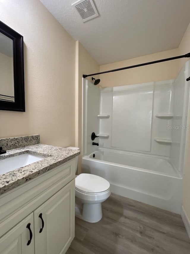 16910 SW 27th Ave, Ocala, FL 34473 - bathroom with vanity, wood finished floors, shower / bath combination, and a textured ceiling
