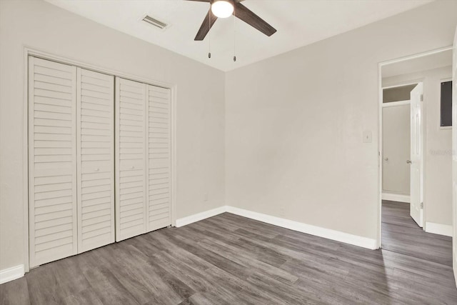 10375 106th Ter, Largo, FL 33773 - unfurnished bedroom featuring dark wood-type flooring, a closet, and a ceiling fan
