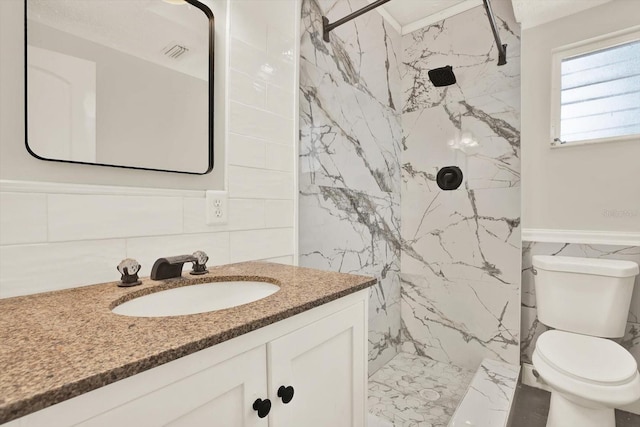 10375 106th Ter, Largo, FL 33773 - full bathroom featuring tile walls, vanity, a marble finish shower, and marble finish flooring