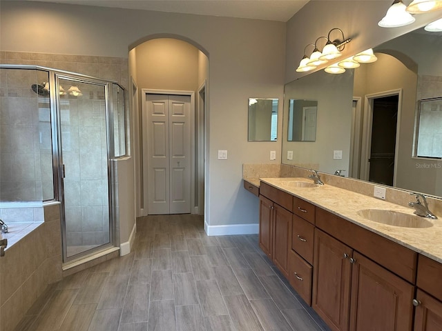 1008 Arista Blvd, Valrico, FL 33594 - bathroom with a closet, a shower stall, double vanity, and tiled tub