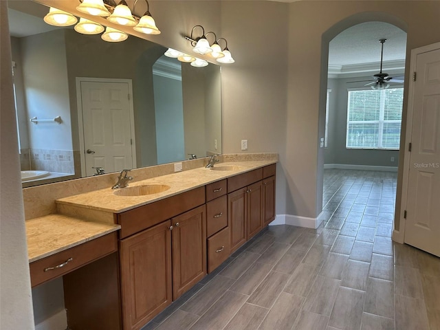 1008 Arista Blvd, Valrico, FL 33594 - full bath with double vanity, crown molding, a bathtub, and a ceiling fan