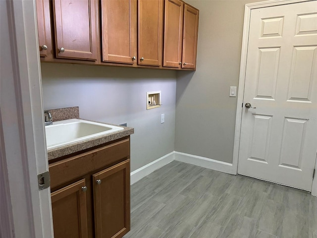 1008 Arista Blvd, Valrico, FL 33594 - laundry room featuring washer hookup, cabinet space, and light wood-style flooring