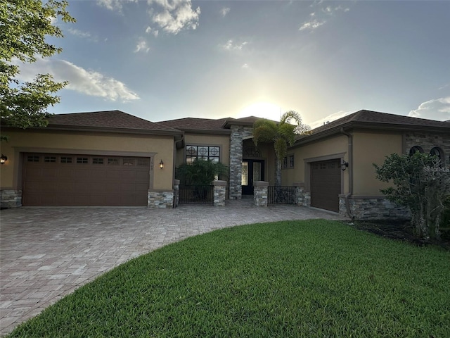 1008 Arista Blvd, Valrico, FL 33594 - prairie-style house featuring an attached garage, stone siding, and stucco siding