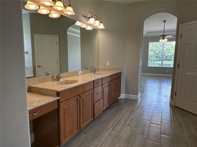1008 Arista Blvd, Valrico, FL 33594 - full bath featuring double vanity, ceiling fan, ornamental molding, and wood finished floors