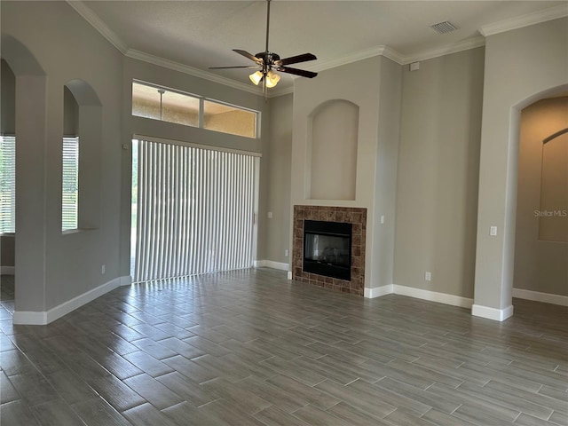 1008 Arista Blvd, Valrico, FL 33594 - unfurnished living room with ceiling fan, wood finished floors, healthy amount of natural light, crown molding, and arched walkways