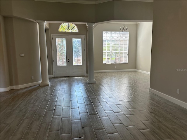 1008 Arista Blvd, Valrico, FL 33594 - entrance foyer featuring decorative columns, wood tiled floors, a chandelier, crown molding, and french doors