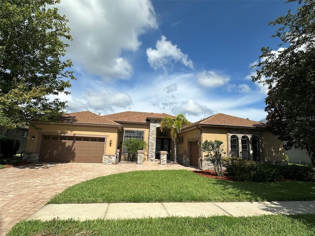 1008 Arista Blvd, Valrico, FL 33594 - view of front of property featuring an attached garage, stucco siding, stone siding, decorative driveway, and a front yard