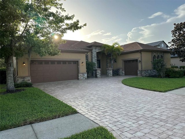 1008 Arista Blvd, Valrico, FL 33594 - view of front of home with stucco siding, stone siding, and a garage