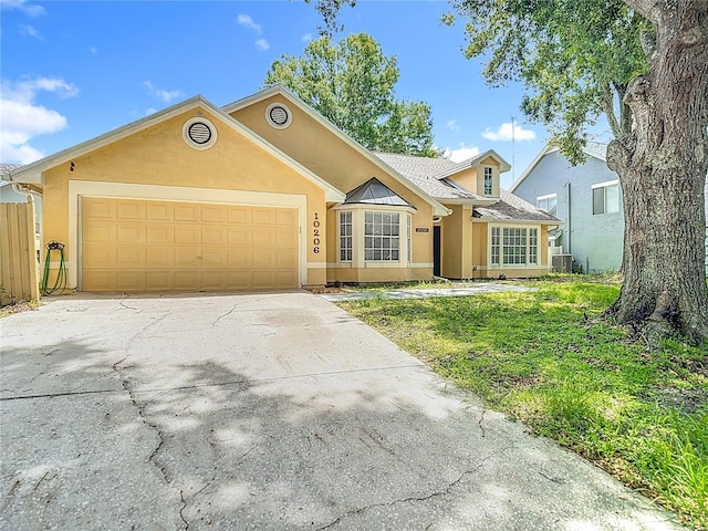 10206 Evening Trail Dr, Riverview, FL 33569 - view of front of house featuring a garage, stucco siding, and driveway