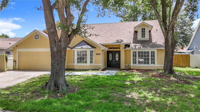 10206 Evening Trail Dr, Riverview, FL 33569 - view of front facade with stucco siding, an attached garage, driveway, and roof with shingles