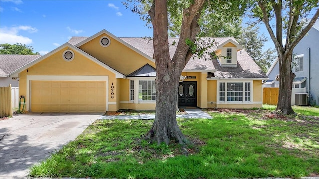 10206 Evening Trail Dr, Riverview, FL 33569 - view of front of home with stucco siding, an attached garage, concrete driveway, and a shingled roof