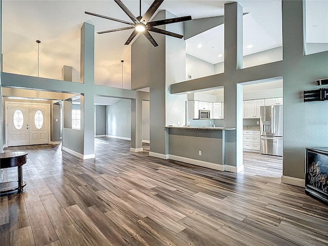 10206 Evening Trail Dr, Riverview, FL 33569 - unfurnished living room with a high ceiling, ceiling fan, dark wood-style flooring, and recessed lighting