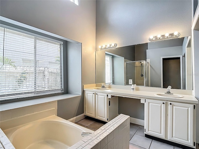 10206 Evening Trail Dr, Riverview, FL 33569 - bathroom with a bath, double vanity, tile patterned floors, and a stall shower