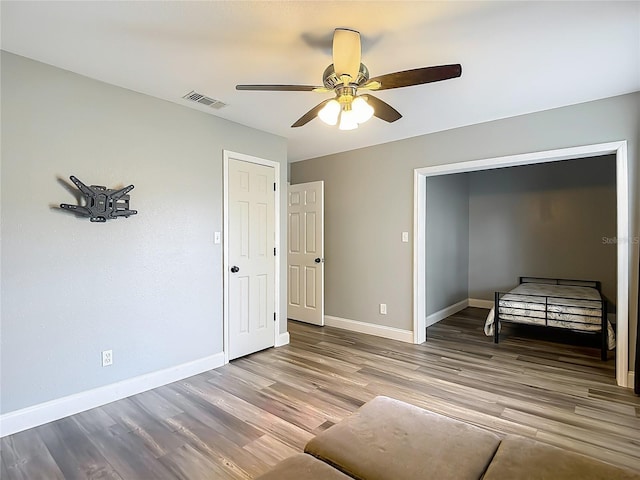 10206 Evening Trail Dr, Riverview, FL 33569 - unfurnished bedroom featuring wood finished floors and ceiling fan
