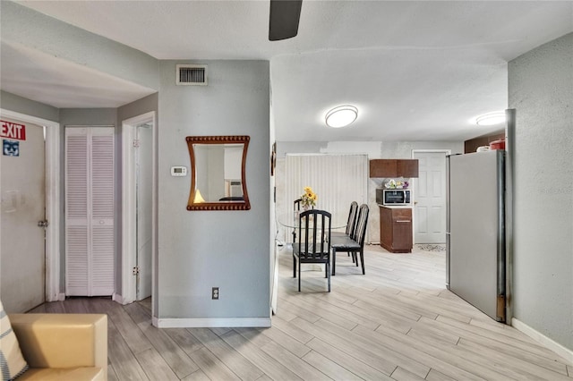 10549 112th Ave, Largo, FL 33773 - hall with baseboards and light wood-style flooring