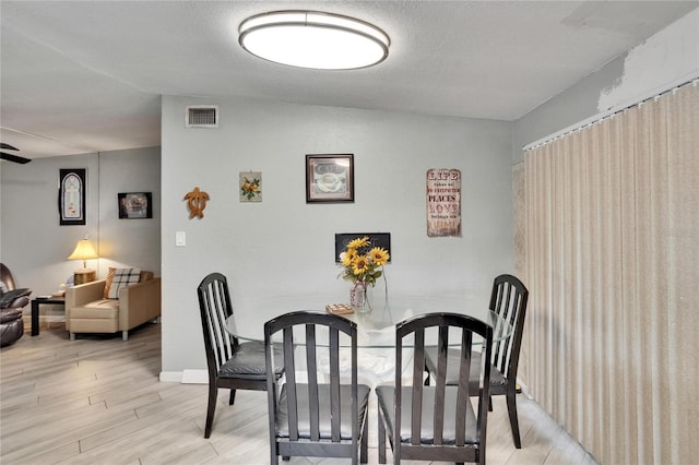 10549 112th Ave, Largo, FL 33773 - dining area with light wood-type flooring and baseboards