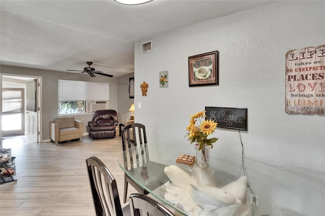10549 112th Ave, Largo, FL 33773 - dining area featuring a ceiling fan, light wood-style flooring, and a textured wall