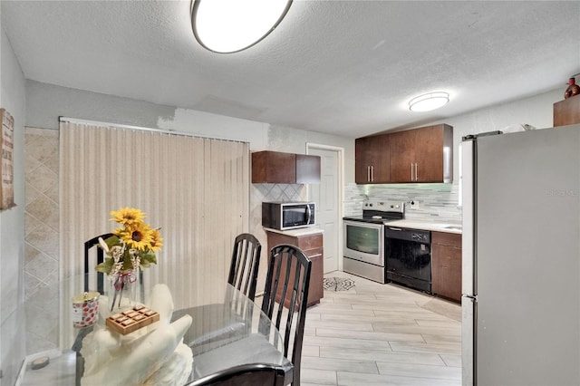 10549 112th Ave, Largo, FL 33773 - kitchen with appliances with stainless steel finishes, light countertops, backsplash, and a textured ceiling