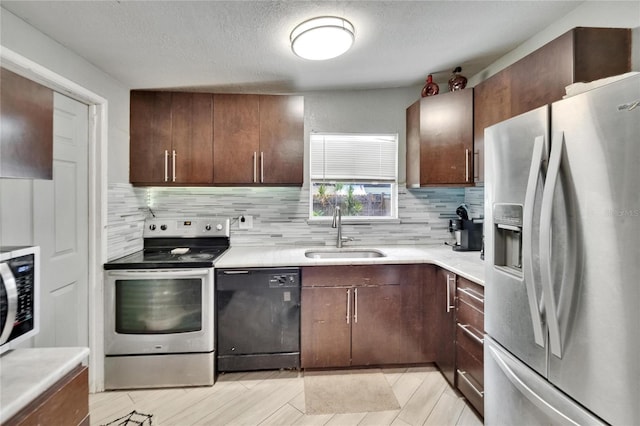 10549 112th Ave, Largo, FL 33773 - kitchen featuring stainless steel appliances, tasteful backsplash, light countertops, a textured ceiling, and dark brown cabinets