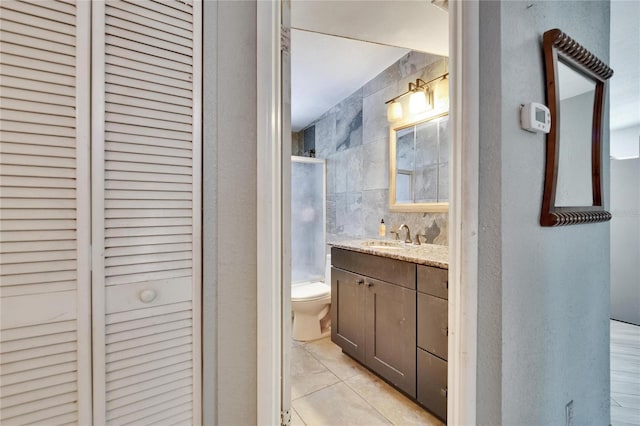 10549 112th Ave, Largo, FL 33773 - full bath featuring tile walls, a closet, vanity, a shower with shower door, and tile patterned flooring