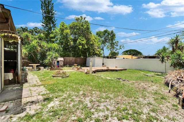 10549 112th Ave, Largo, FL 33773 - fenced backyard with a storage shed and a wooden deck