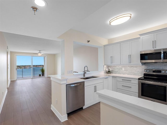 7979 Sailboat Key Blvd S Unit 505, South Pasadena, FL 33707 - kitchen with stainless steel appliances, tasteful backsplash, light countertops, and open floor plan