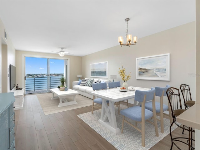 7979 Sailboat Key Blvd S Unit 505, South Pasadena, FL 33707 - dining room with wood finished floors, a chandelier, and ceiling fan