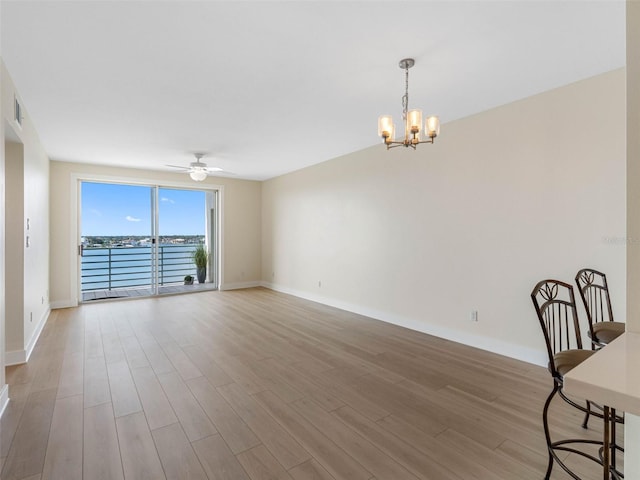 7979 Sailboat Key Blvd S Unit 505, South Pasadena, FL 33707 - spare room with a chandelier, wood finished floors, ceiling fan, and a water view