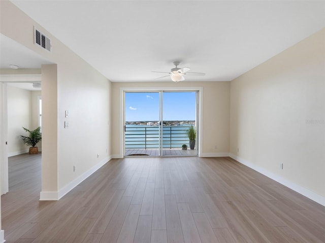 7979 Sailboat Key Blvd S Unit 505, South Pasadena, FL 33707 - spare room featuring a ceiling fan, healthy amount of natural light, and light wood-style flooring