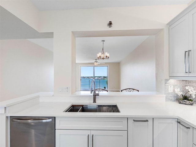 7979 Sailboat Key Blvd S Unit 505, South Pasadena, FL 33707 - kitchen with dishwasher, a chandelier, a peninsula, backsplash, and light countertops